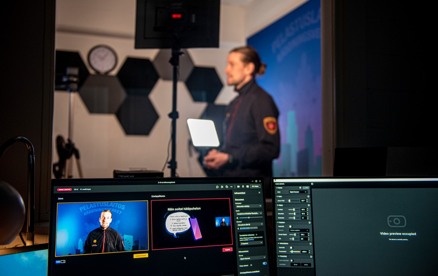 Palomies pitää virtuaalioppituntia pelastuslatoksen studiolta.
