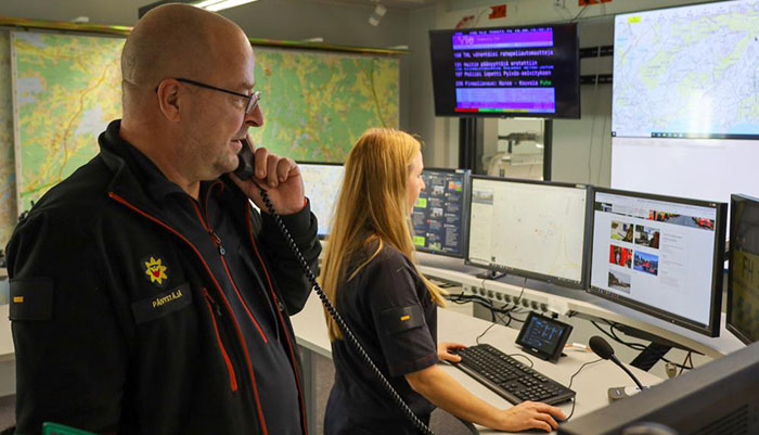  Two persons at the situation centre of rescue department. 