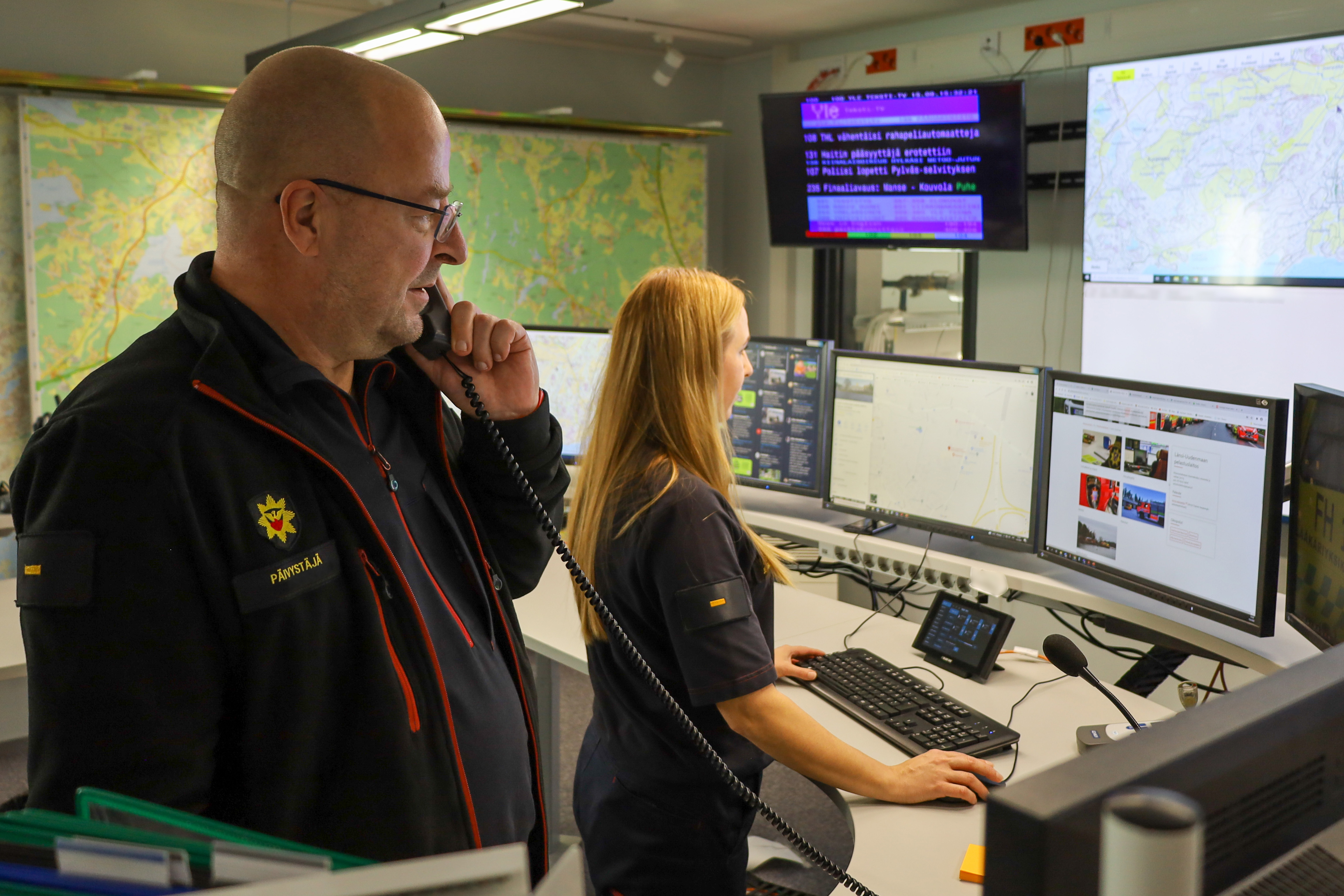  Two persons at the situation centre of rescue department. 
